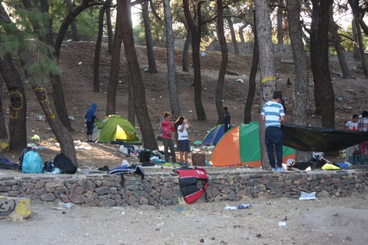 A mother brushes her daugher's hair in a tent camp near the port where mostly Afghans stay.