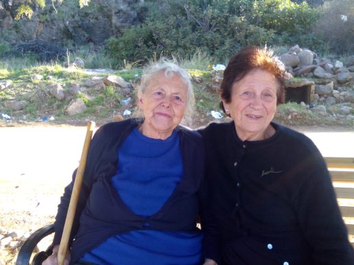 Marissa Mavrapidou who was photographed comforting a refugee baby sits with her cousin Konstantina outside Sikaminias camp